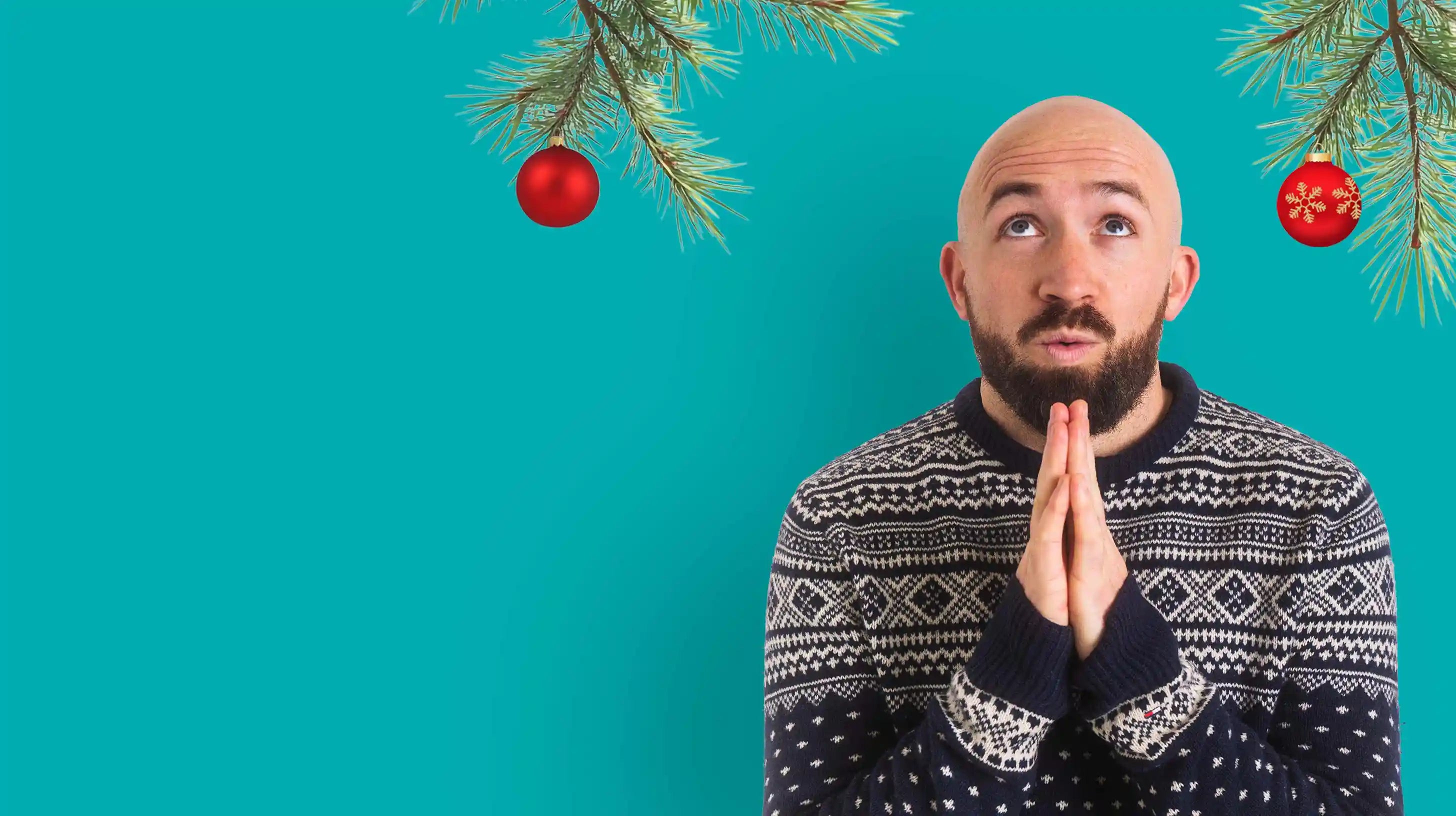 Bald Man Praying with Christmas Jumper