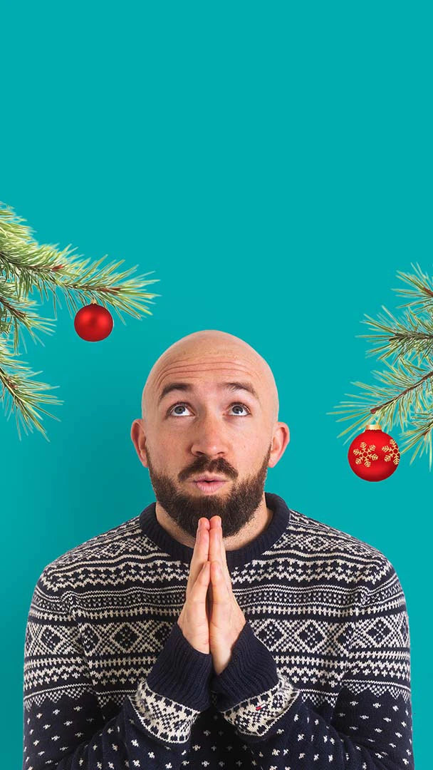 Bald Man Praying with Christmas Jumper